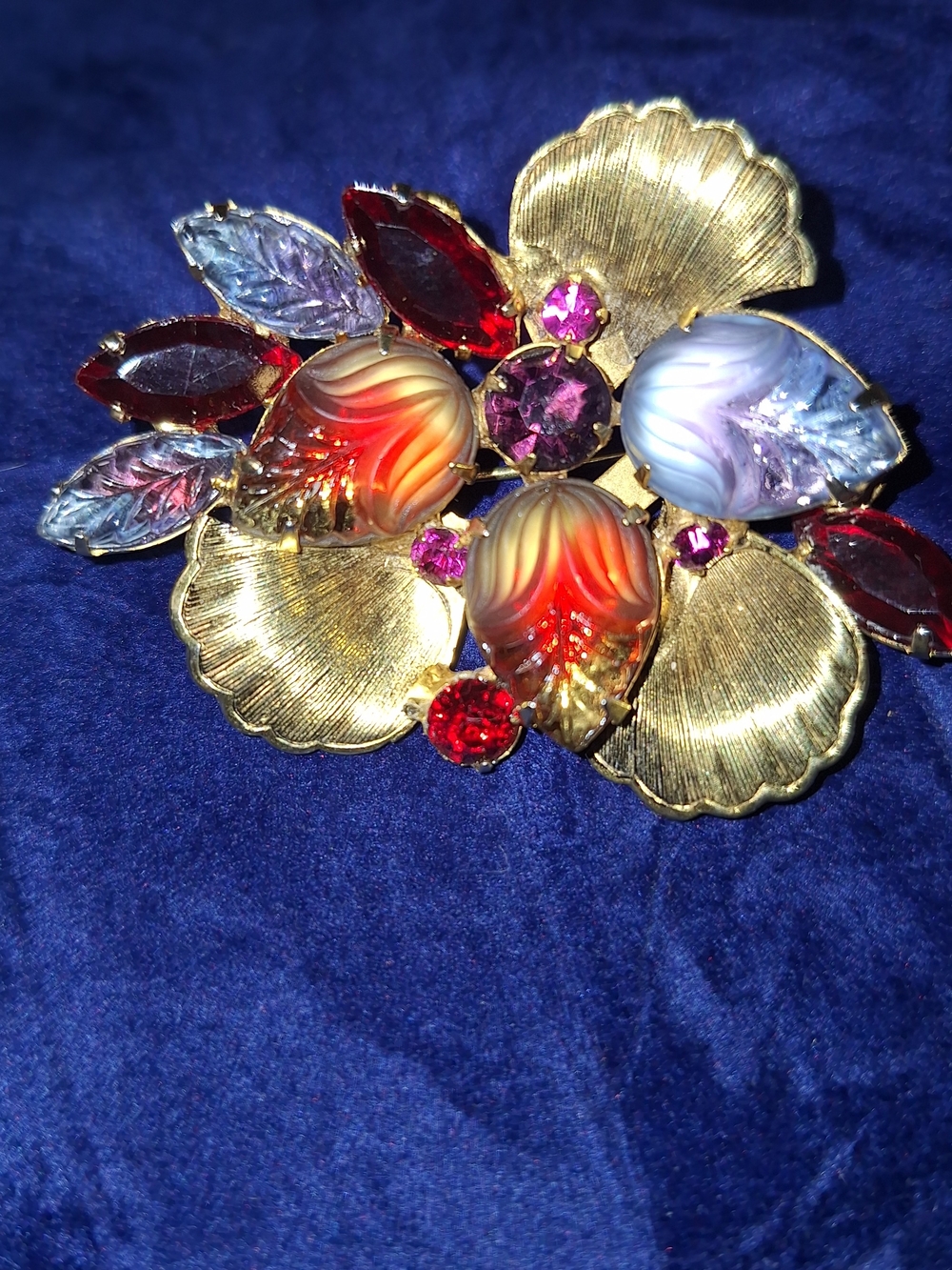 Vintage gold-tone floral brooch features multi-colored molded givre glass